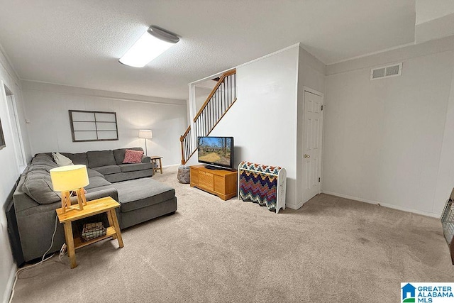 living area featuring stairs, carpet flooring, visible vents, and a textured ceiling