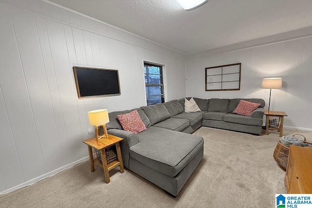 carpeted living room featuring baseboards, a textured ceiling, and crown molding