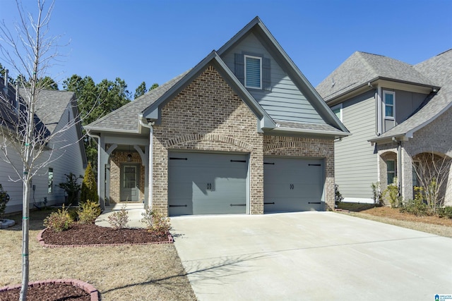 view of front of house with brick siding, an attached garage, driveway, and roof with shingles