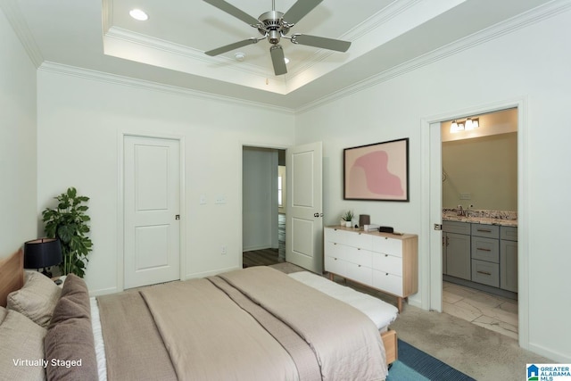 bedroom with connected bathroom, crown molding, a tray ceiling, light carpet, and recessed lighting