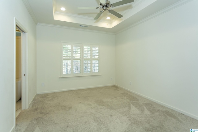 unfurnished room featuring visible vents, crown molding, ceiling fan, carpet flooring, and a raised ceiling