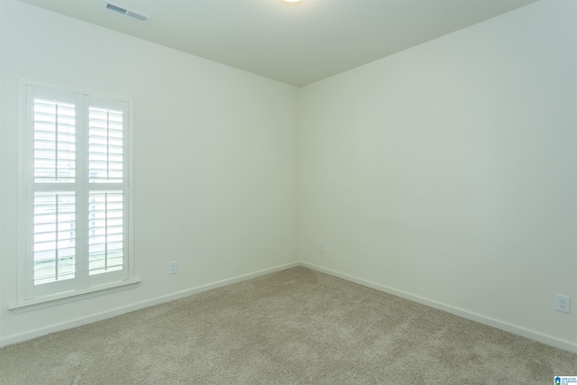 unfurnished room with visible vents, carpet floors, and baseboards