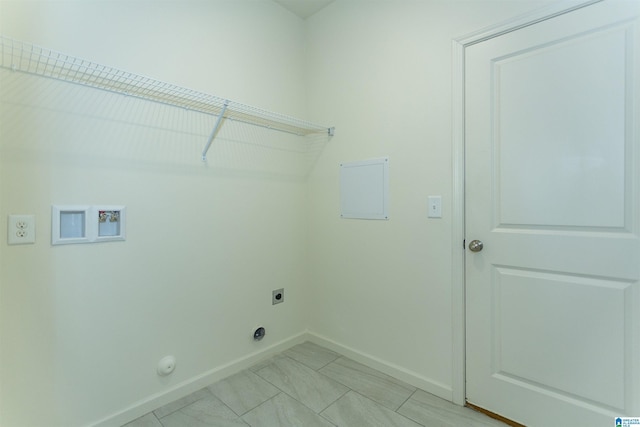 laundry room with laundry area, hookup for a washing machine, hookup for an electric dryer, and baseboards