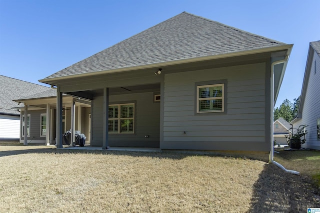 rear view of property with a patio area and a shingled roof