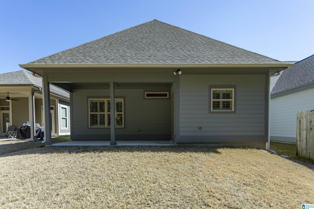 back of house with a patio, a ceiling fan, and roof with shingles