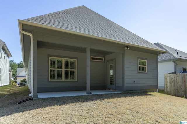 back of house featuring cooling unit, fence, a patio area, and a shingled roof