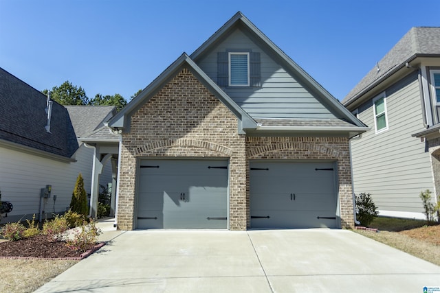 view of front facade featuring concrete driveway and brick siding