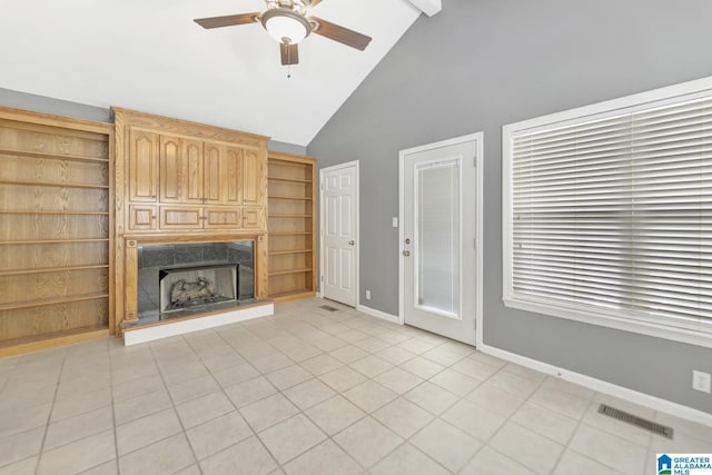 unfurnished living room featuring visible vents, a ceiling fan, light tile patterned floors, a premium fireplace, and baseboards