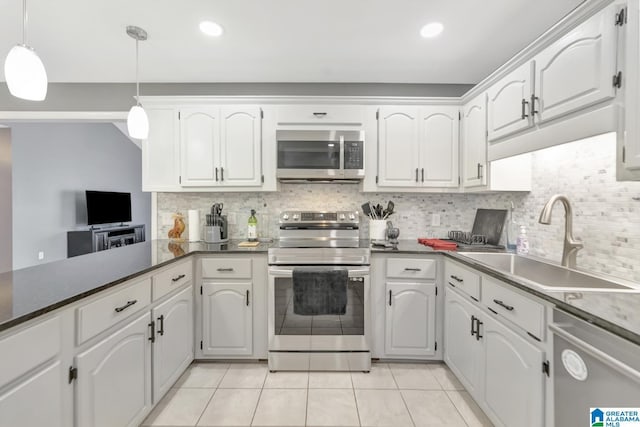 kitchen with backsplash, decorative light fixtures, light tile patterned flooring, stainless steel appliances, and a sink