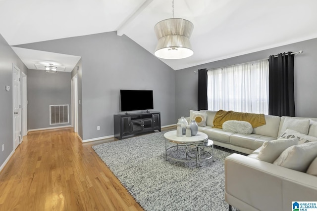 living area with vaulted ceiling with beams, baseboards, visible vents, and light wood finished floors