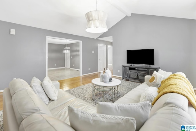 living room with vaulted ceiling with beams, baseboards, and wood finished floors