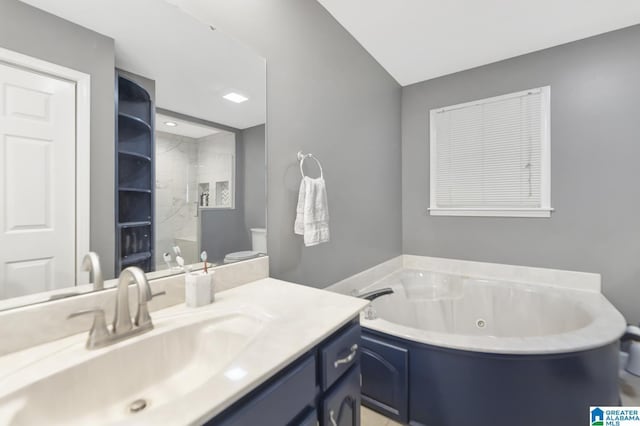 bathroom featuring vanity, a jetted tub, and a walk in shower