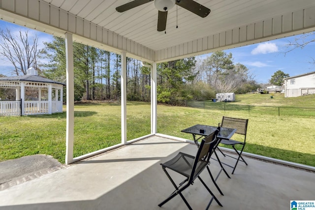 unfurnished sunroom with a ceiling fan