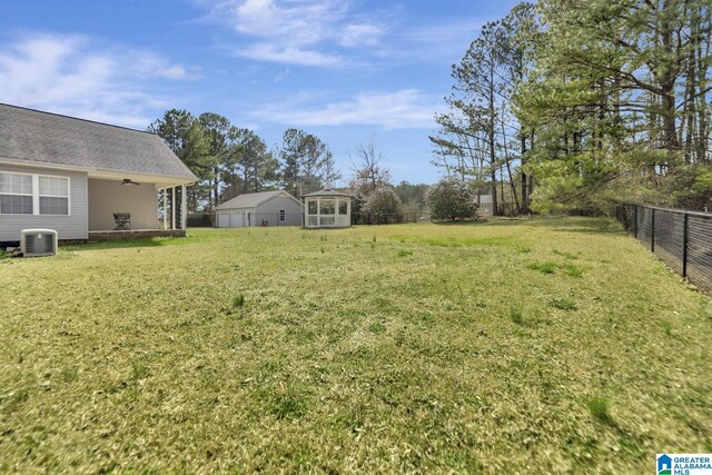 view of yard featuring cooling unit, a fenced backyard, and ceiling fan