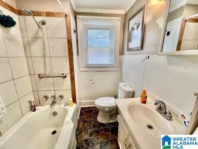 full bathroom with toilet, tile walls, crown molding, shower / bath combination, and vanity