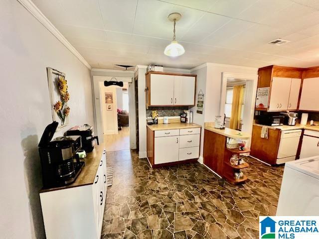 kitchen with crown molding, white cabinets, washer / clothes dryer, and light countertops