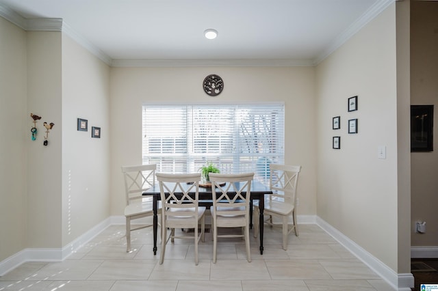 dining area featuring light tile patterned floors, baseboards, and ornamental molding