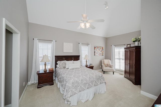 bedroom featuring baseboards, multiple windows, and light carpet