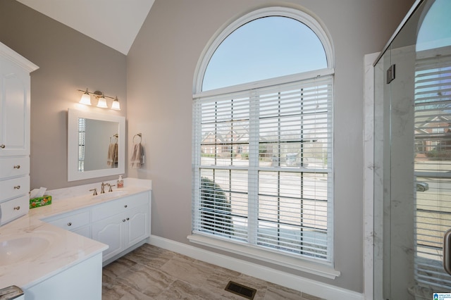 bathroom with vanity, a shower stall, visible vents, and lofted ceiling