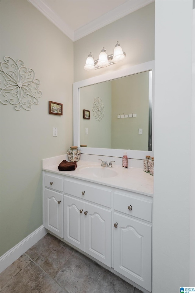 bathroom featuring tile patterned flooring, vanity, crown molding, and baseboards