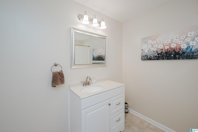 bathroom featuring tile patterned flooring, vanity, and baseboards