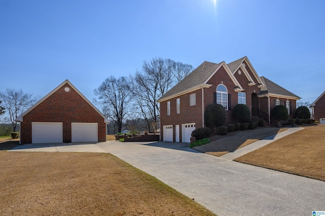 view of side of property featuring brick siding, concrete driveway, and a yard