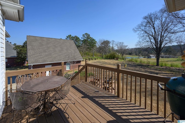 wooden deck featuring area for grilling and outdoor dining space