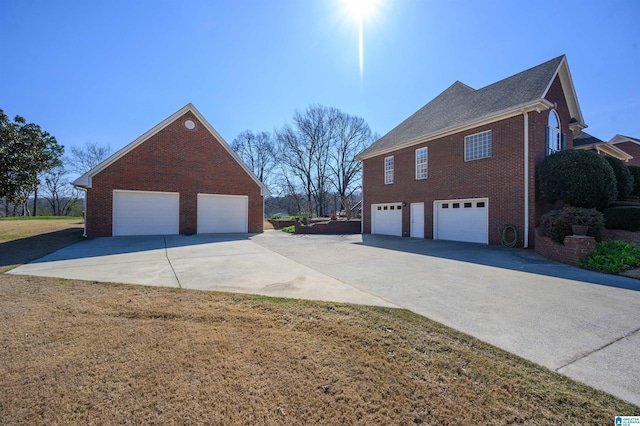 view of home's exterior featuring a garage, brick siding, and a lawn