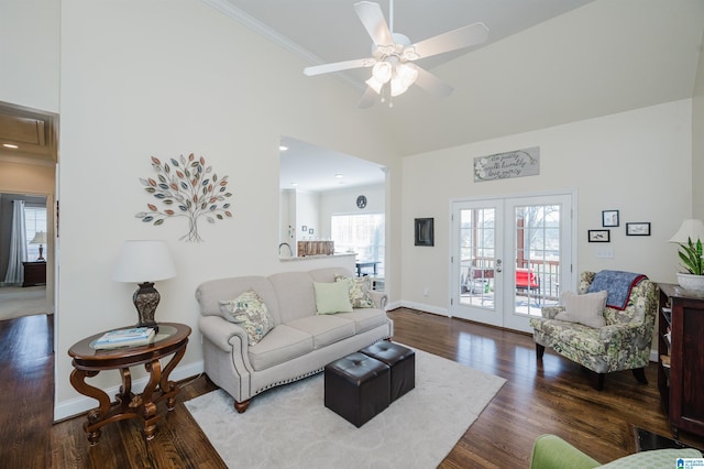 living area featuring crown molding, baseboards, french doors, wood finished floors, and a ceiling fan