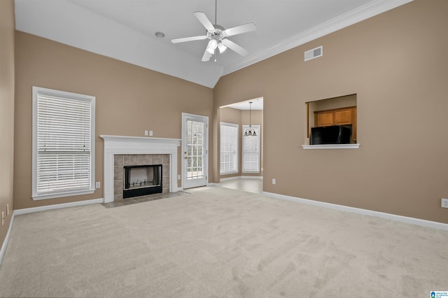 unfurnished living room with baseboards, visible vents, a fireplace, ceiling fan, and light colored carpet