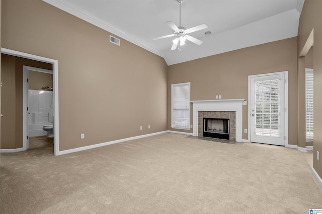 unfurnished living room with light carpet, visible vents, a fireplace, and ceiling fan