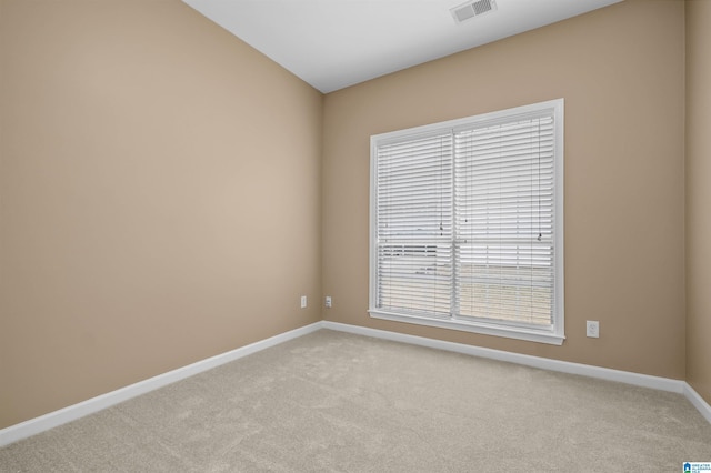 unfurnished room with carpet flooring, baseboards, and visible vents