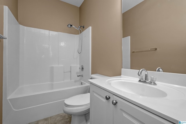 bathroom featuring tile patterned flooring, toilet, vanity, and bathtub / shower combination