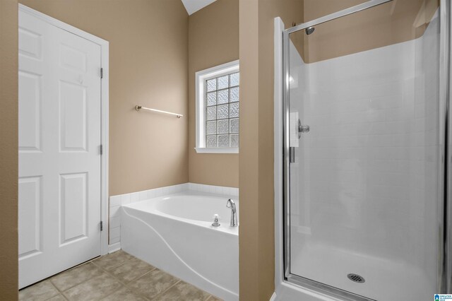 full bath featuring tile patterned floors, a bath, and a shower stall