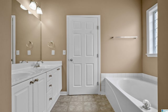 bathroom featuring tile patterned floors, a bath, double vanity, and a sink