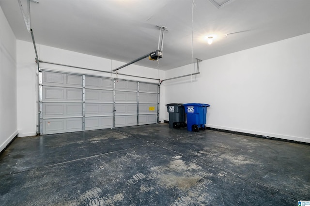 garage with baseboards and a garage door opener