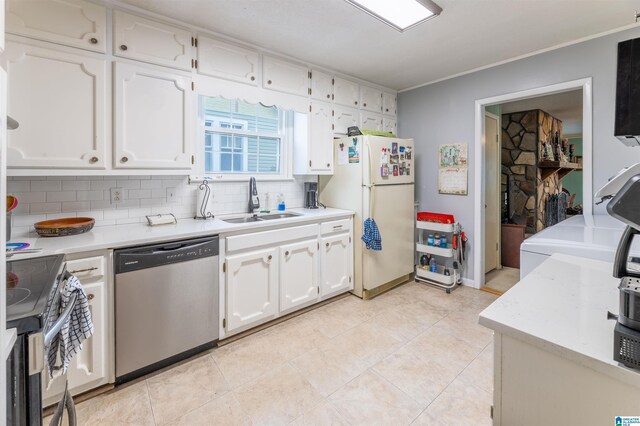 819 Jefferson Ave, Anniston, AL 36207 - kitchen with backsplash, appliances with stainless steel finishes, white cabinetry, and a sink