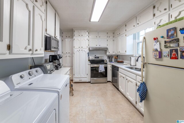 819 Jefferson Ave, Anniston, AL 36207 - kitchen with a sink, stainless steel appliances, white cabinets, light countertops, and washing machine and clothes dryer