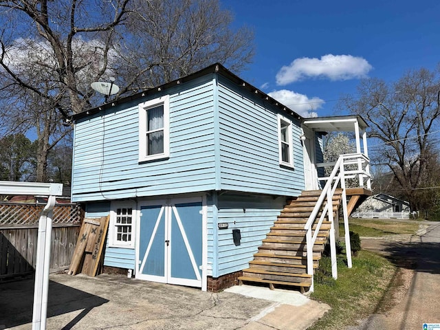 exterior space featuring stairs and fence