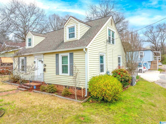 819 Jefferson Ave, Anniston, AL 36207 - cape cod home with a front yard, central AC unit, and a shingled roof