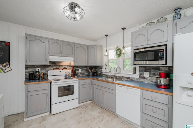 5242 Roy Dr, Helena, AL 35080 - kitchen featuring white appliances, gray cabinets, under cabinet range hood, tasteful backsplash, and a textured ceiling