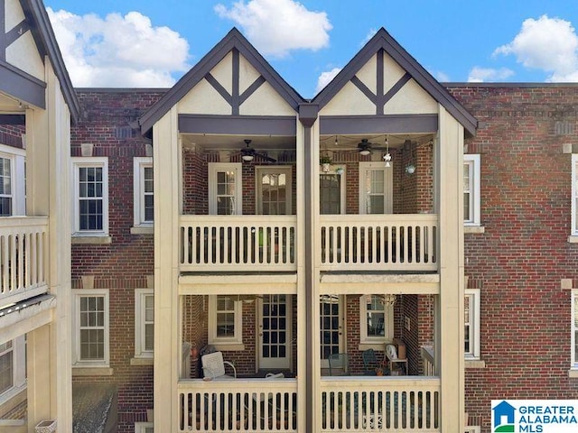 back of property featuring brick siding and ceiling fan