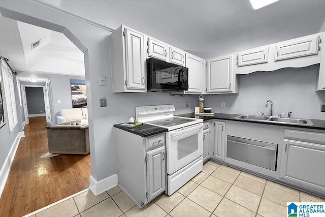 kitchen with visible vents, black microwave, light tile patterned floors, white electric stove, and a sink