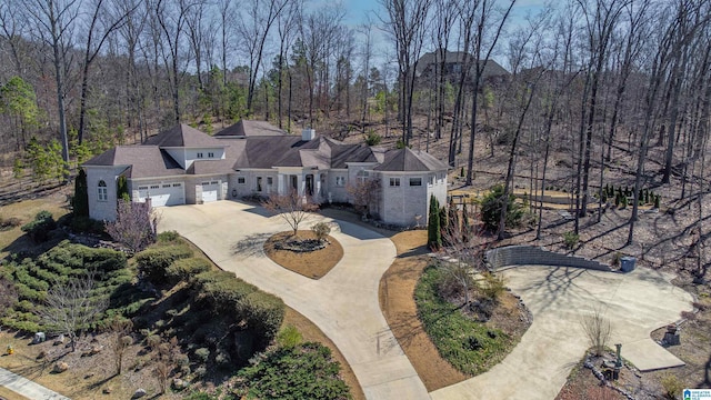 drone / aerial view featuring a wooded view