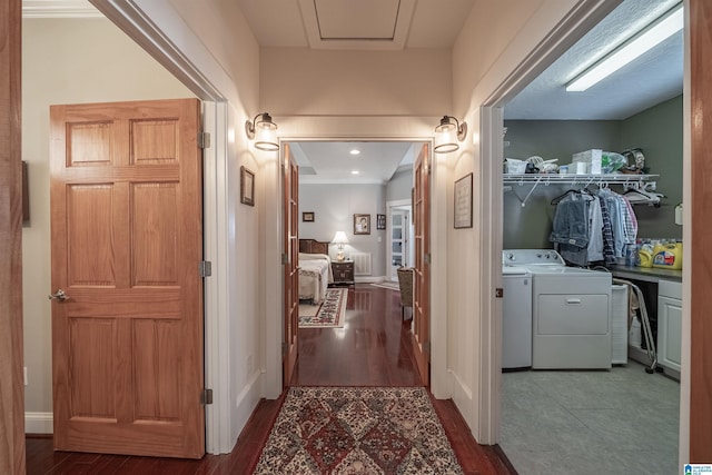 hall with baseboards, wood finished floors, and washer and clothes dryer