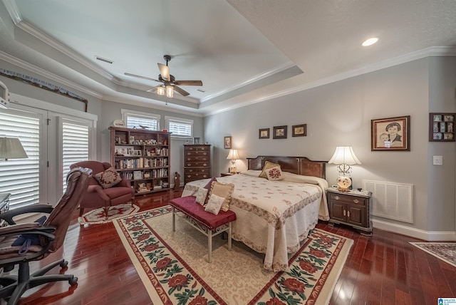 bedroom featuring a raised ceiling, visible vents, and dark wood-style flooring