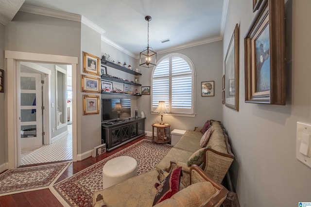 living area featuring visible vents, baseboards, dark wood-type flooring, and crown molding