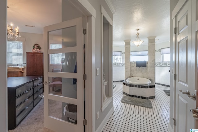 full bathroom featuring vanity, visible vents, decorative columns, a garden tub, and a chandelier