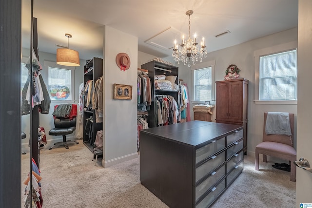 walk in closet featuring visible vents, light carpet, and a notable chandelier