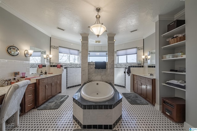 full bath featuring visible vents, a garden tub, ornamental molding, a textured ceiling, and a sink